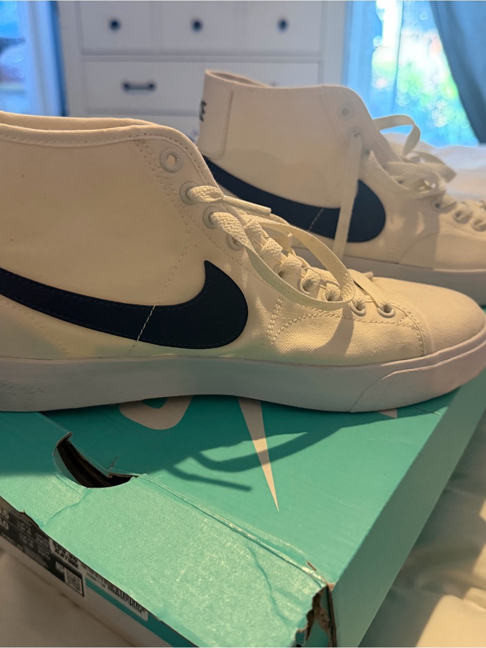 Nike White High-Top Sneakers with Black Swoosh